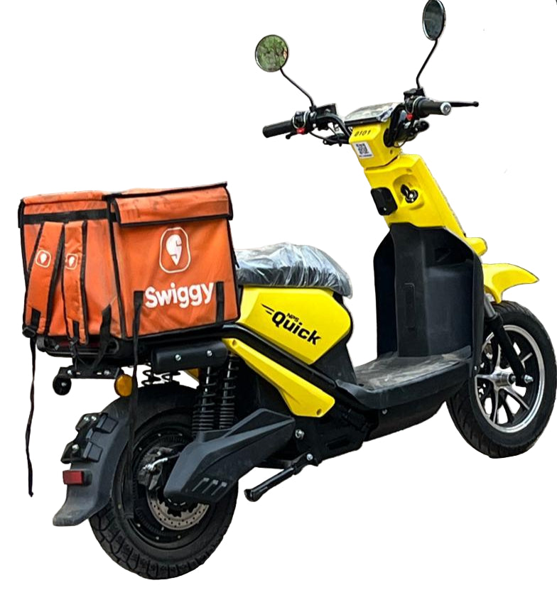 Yellow NPS Quick with an orange Swiggy delivery bag on a street.